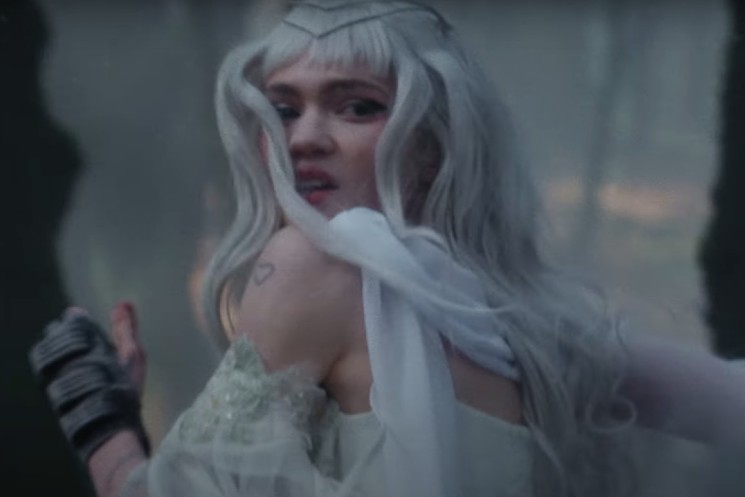 Grimes and Elon Musk Stand-In Face Off in Player of Games Music Video  Trailer